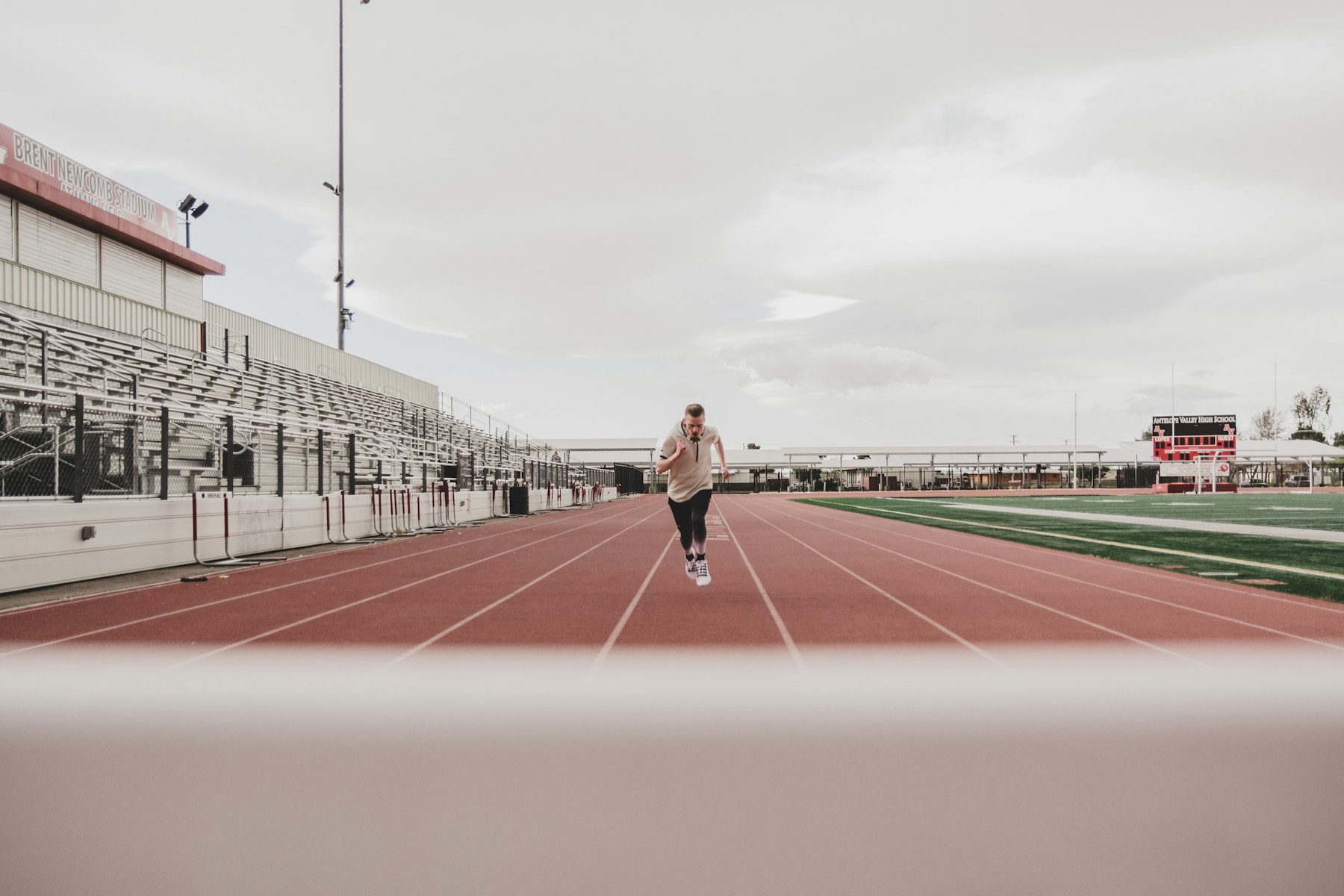 A runner on an open outdoor track